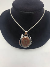 Agate pendant, with diamond accent stones.